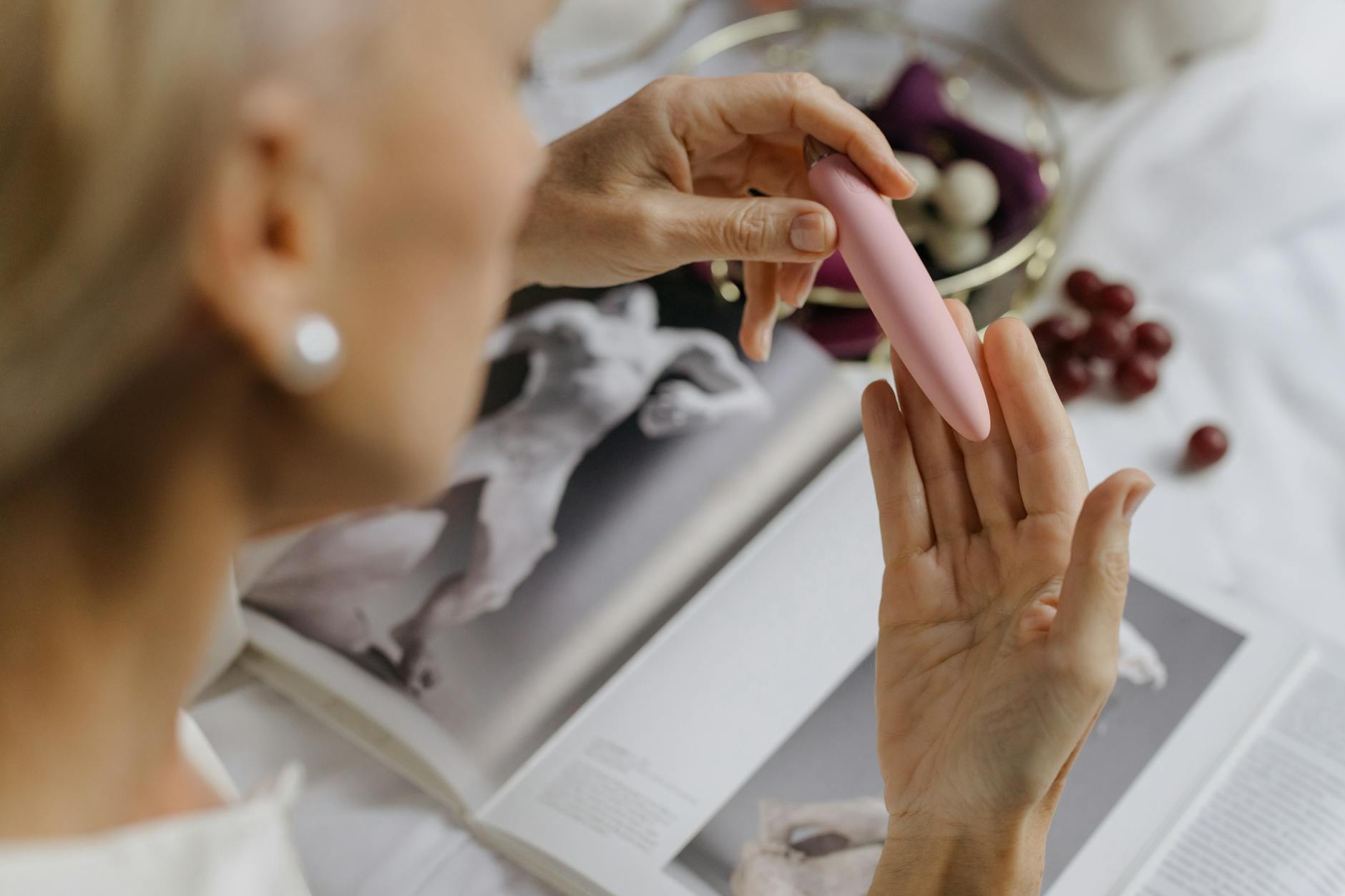 Close-up of hands exploring intimately with a vibrator in a partnership setting